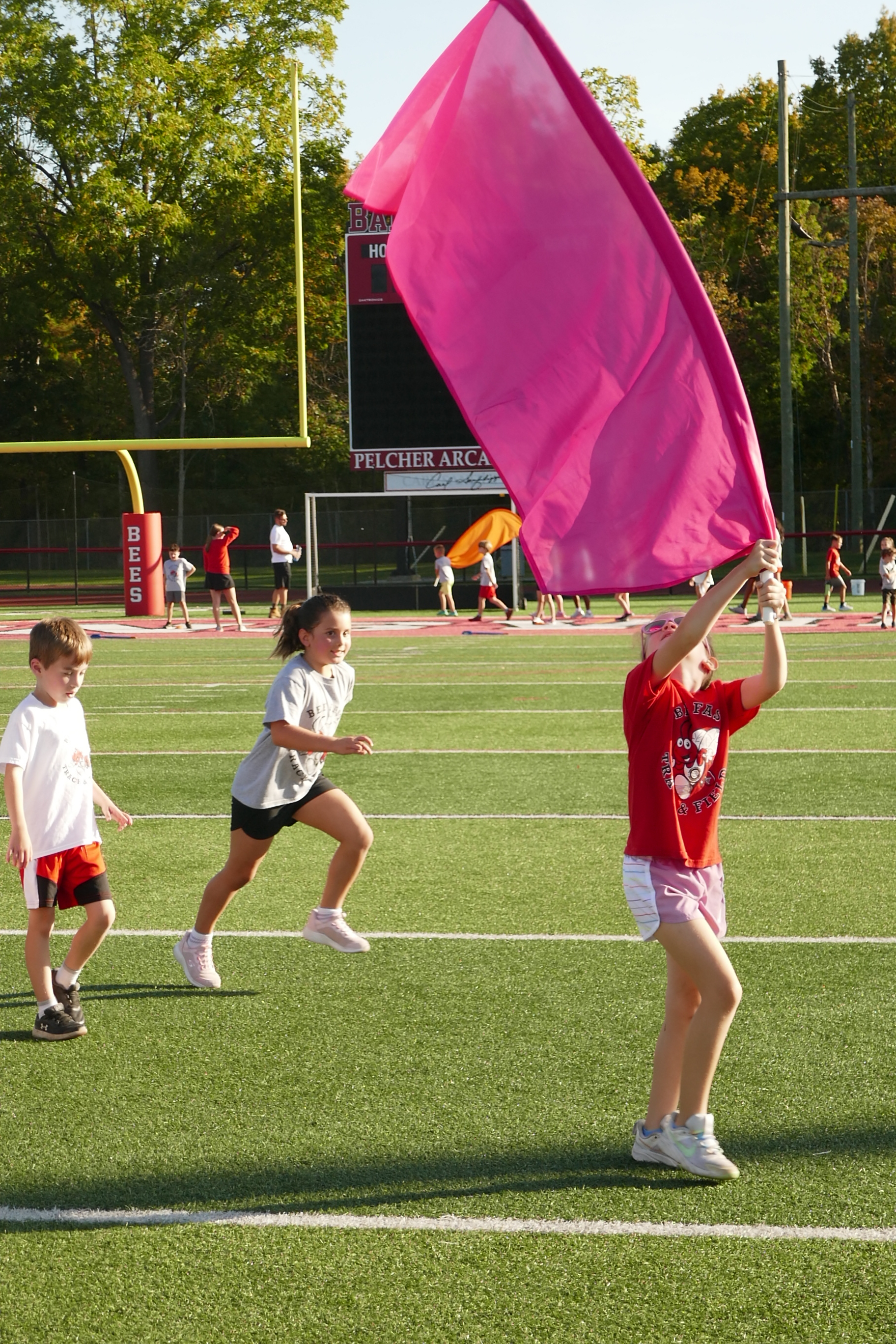 Child carrying tall flag